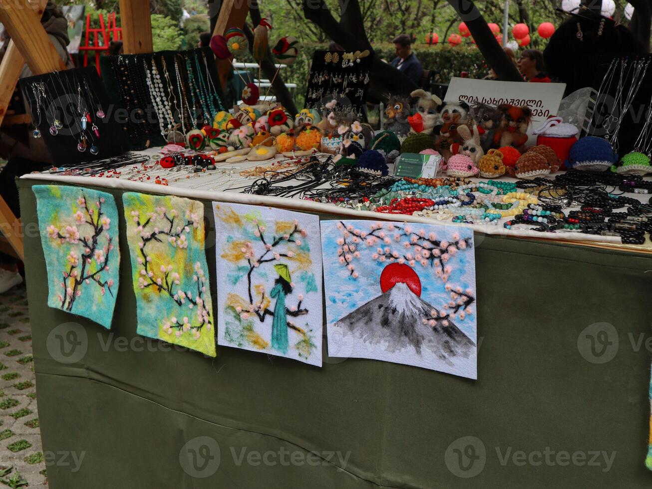 Handcrafted Jewelry and Artwork Display at Outdoor Market photo