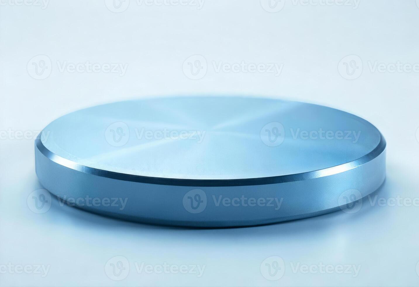 A shiny metallic blue cylinder on a white surface, the cylinder has a smooth, reflective surface, the background is plain white photo