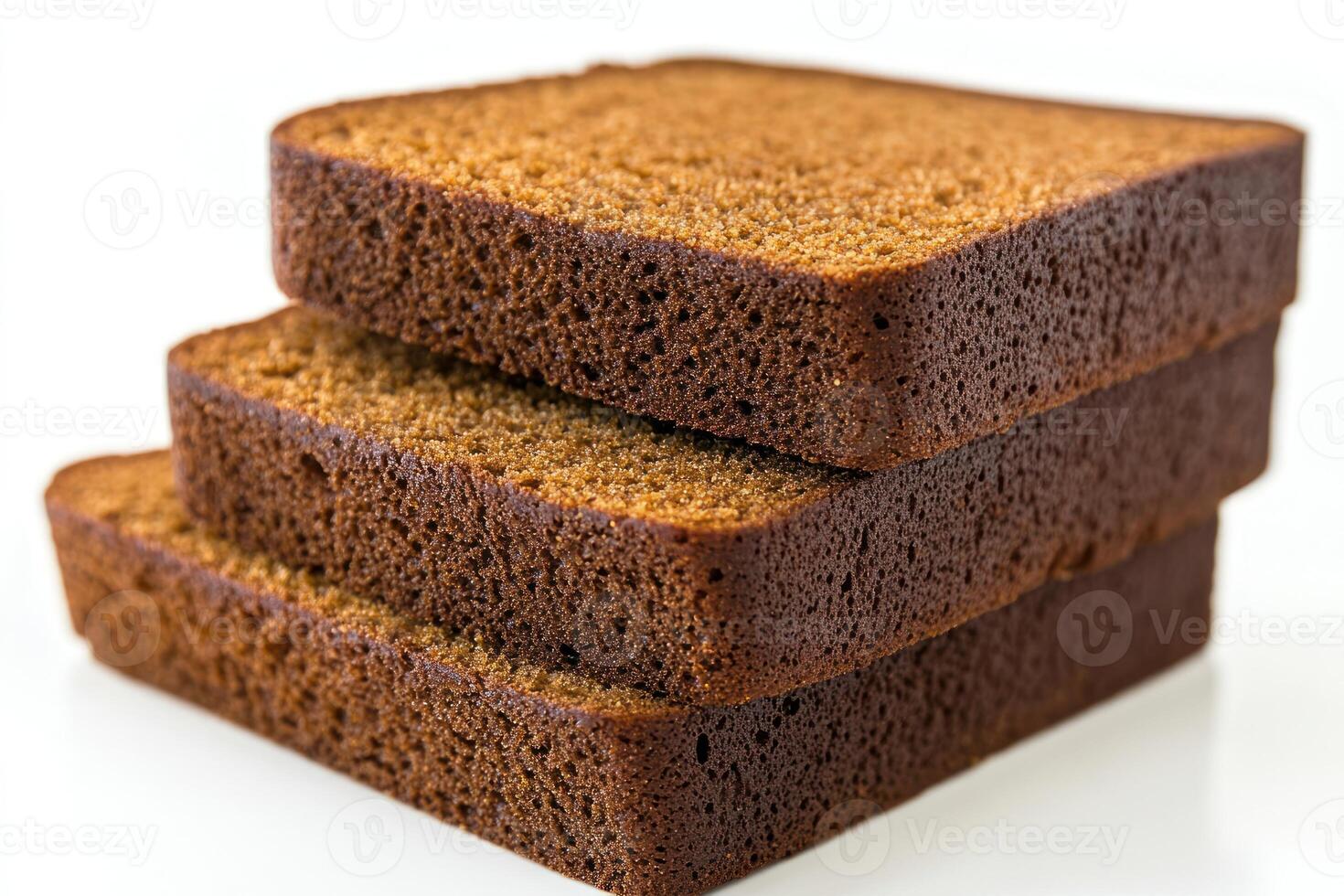 Freshly baked slices of dark bread stacked neatly on a white background photo