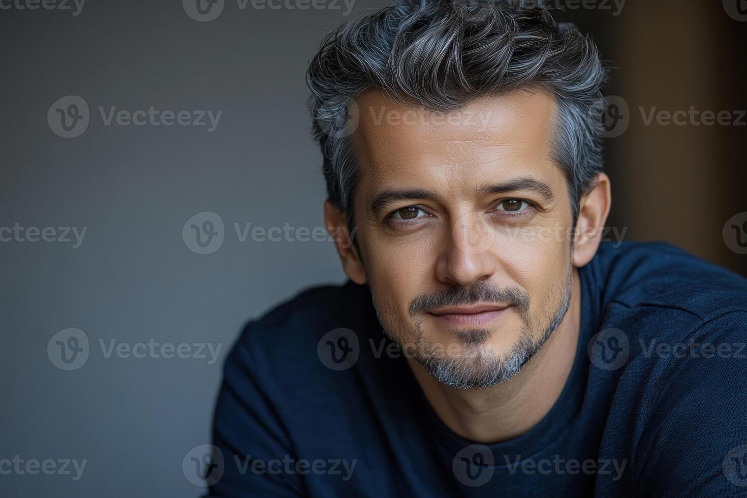 Handsome man smiling with gray hair and beard in a casual setting indoors photo