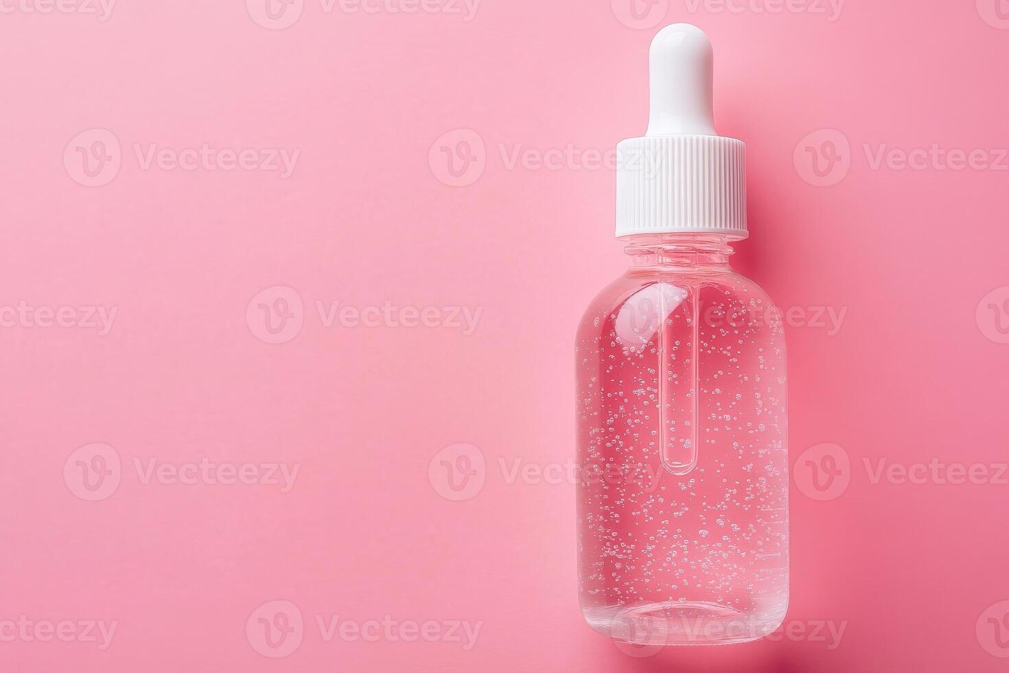 Transparent acid gel texture, skincare serum pink background. photo