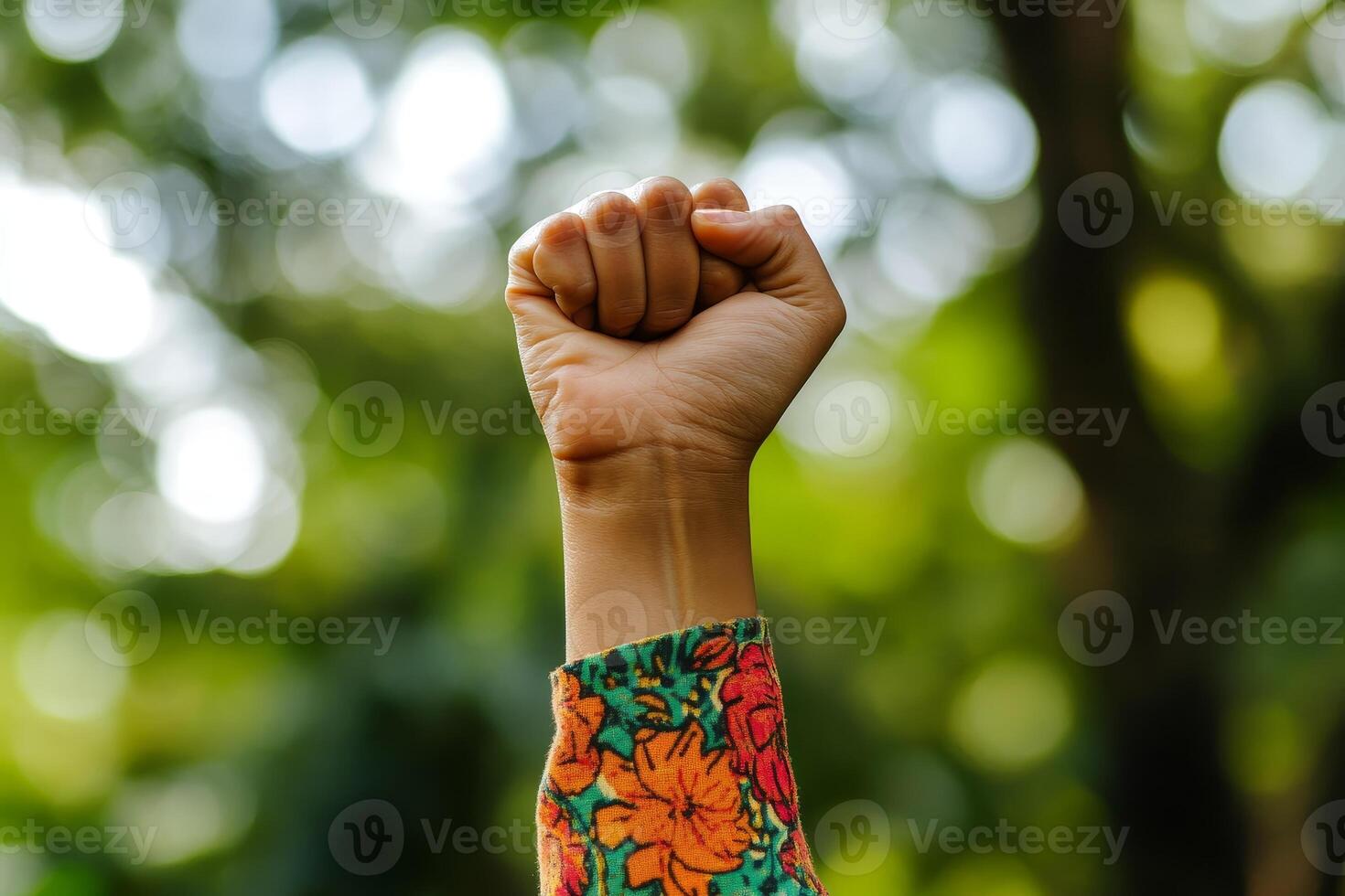 Raised fist of a woman, outdoor. photo