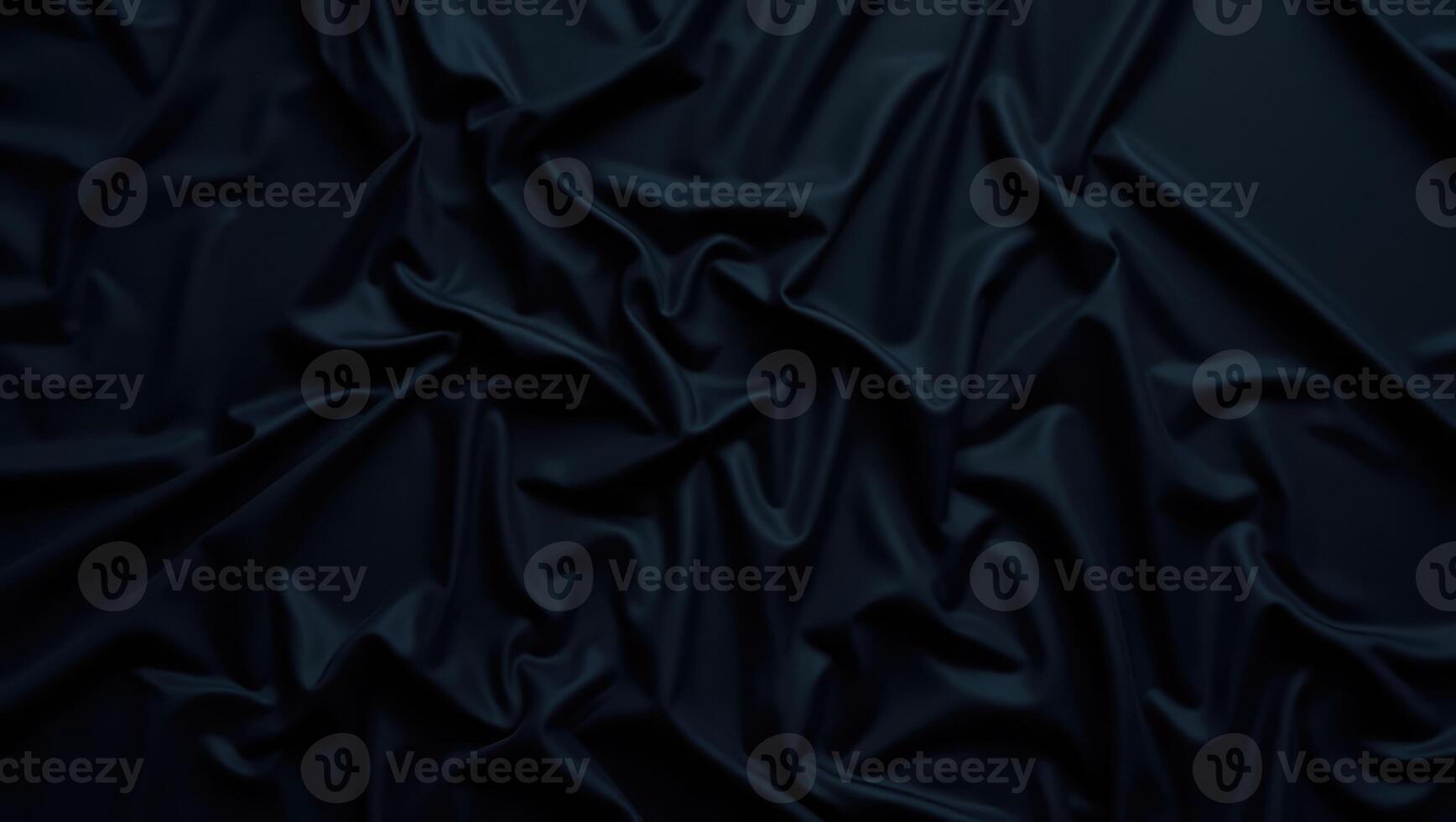 Elegant black fabric draped and folded on a surface creating subtle shadows and texture in a well lit setting photo
