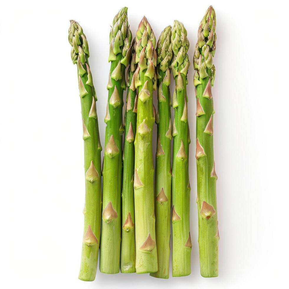 Green asparagus stalks with closed tips and white marks on top, arranged in a bundle. photo
