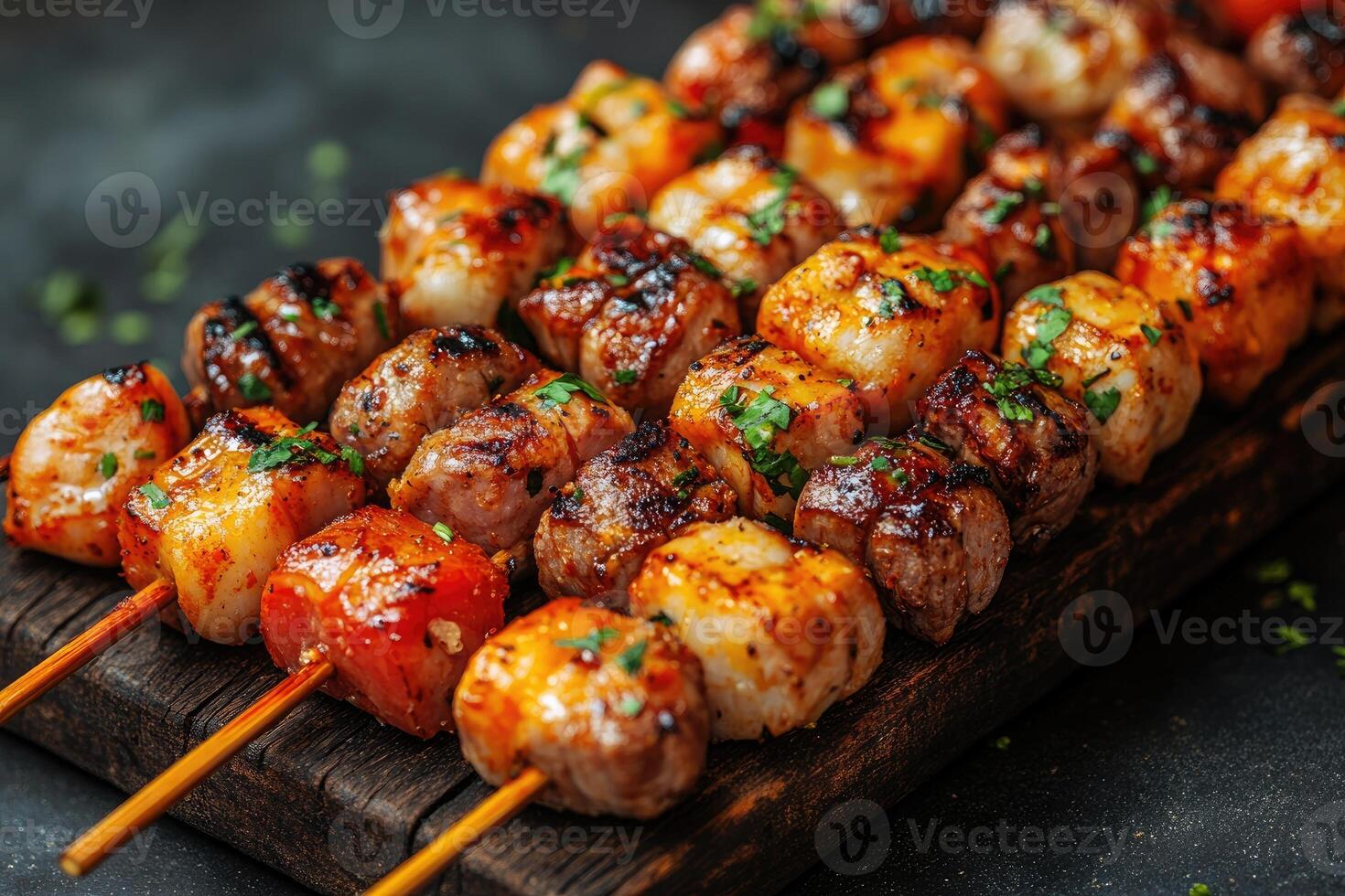 Grilled Meat and Scallops Skewers with Herbs on Wooden Board photo