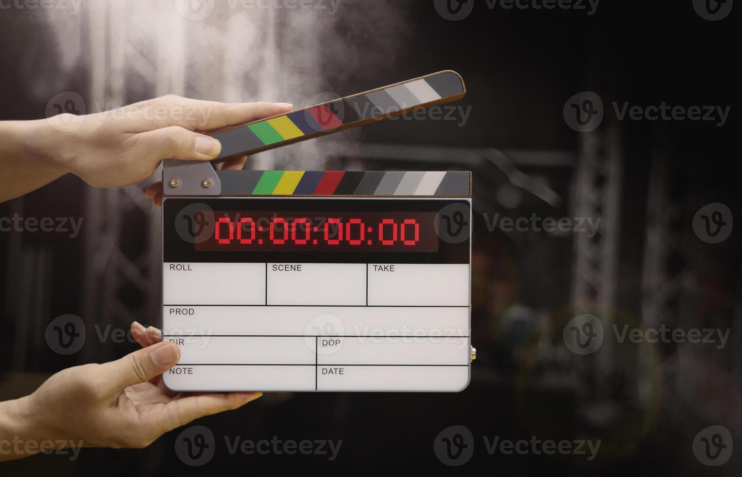 Digital film slate for filmmaker in set. Hand hitting timecode clapperboard or movie slate for Production. Digi number clapper board or film slates action on set. Tools in modern cinema industry. photo