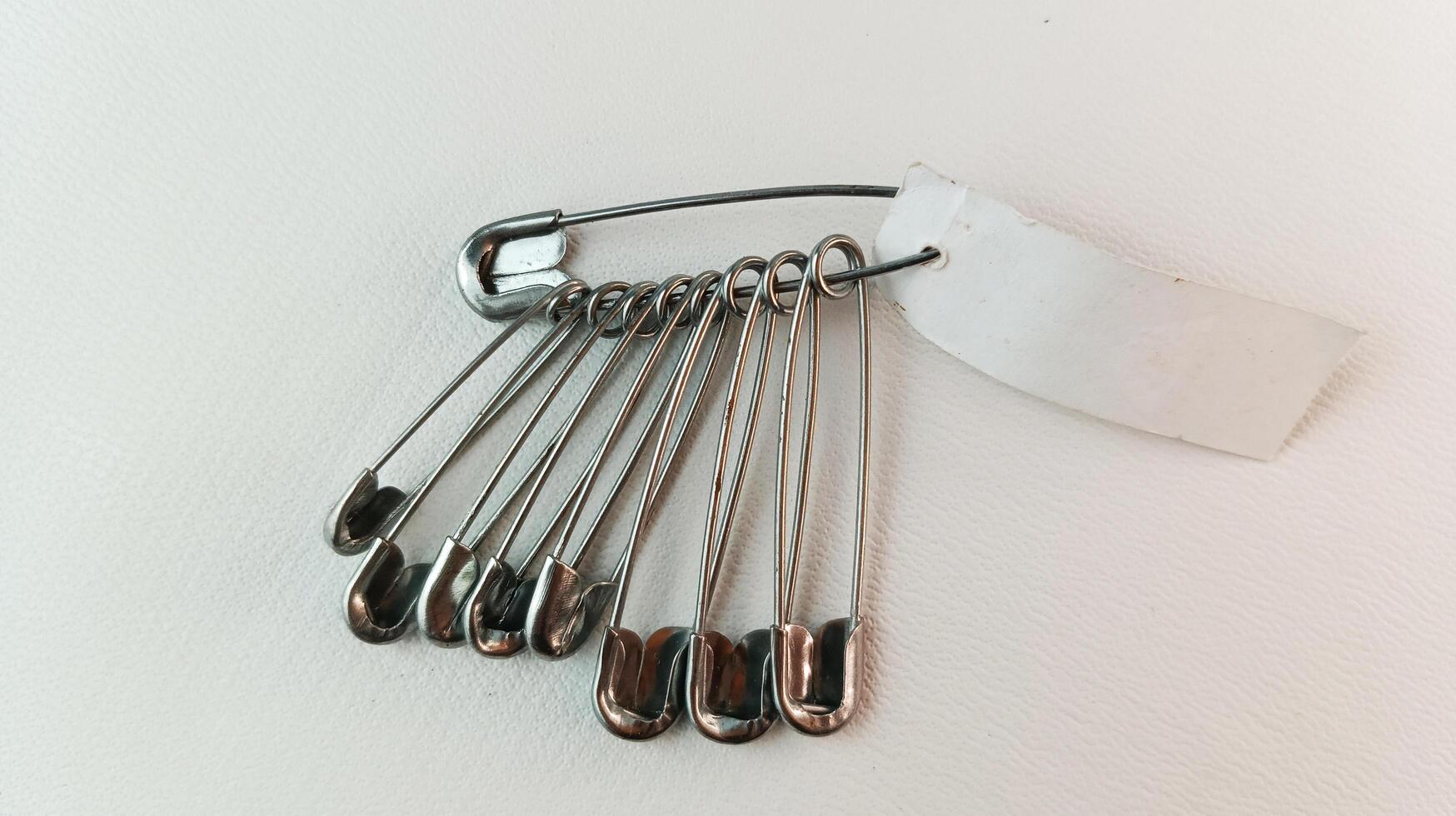 Safety pins in various sizes isolated. photo