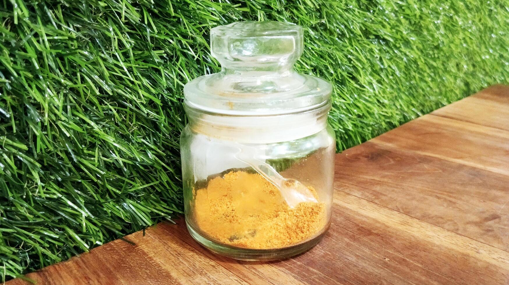 The chili powder is in a small glass jar. photo