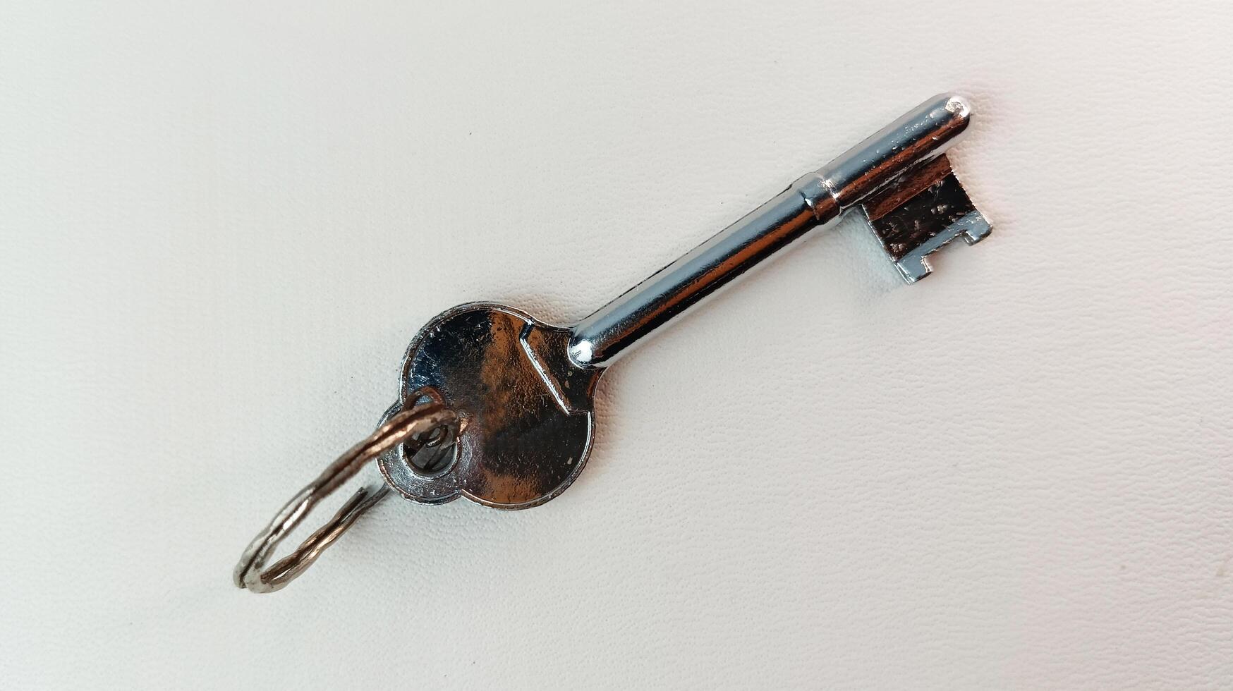 Antique house key isolated on background, key intact. photo