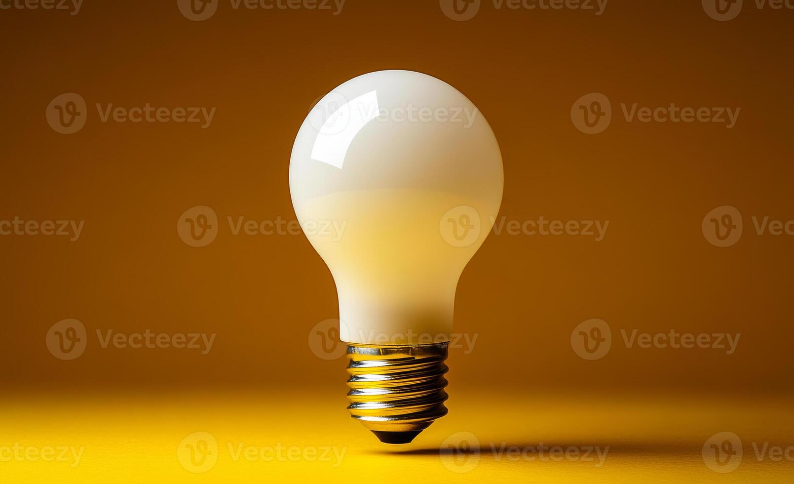 Light bulb on yellow bg. A light bulb floats in mid-air, casting soft reflections on its smooth surface against a vibrant yellow background. photo