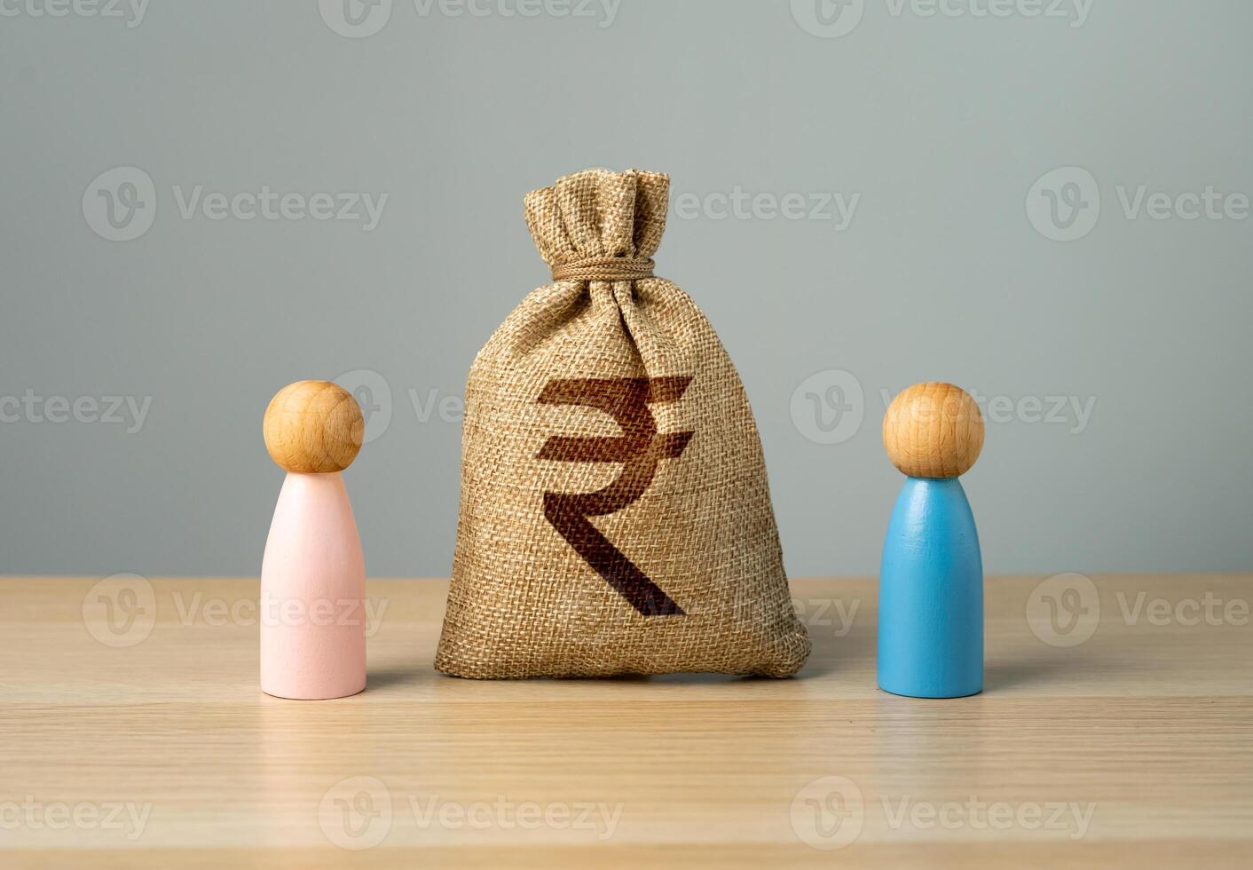 A couple of people of the opposite sex with a money bag of Indian rupees between them. Joint budget, major purchase. Insurance and marriage contract. Division of property during divorce. photo