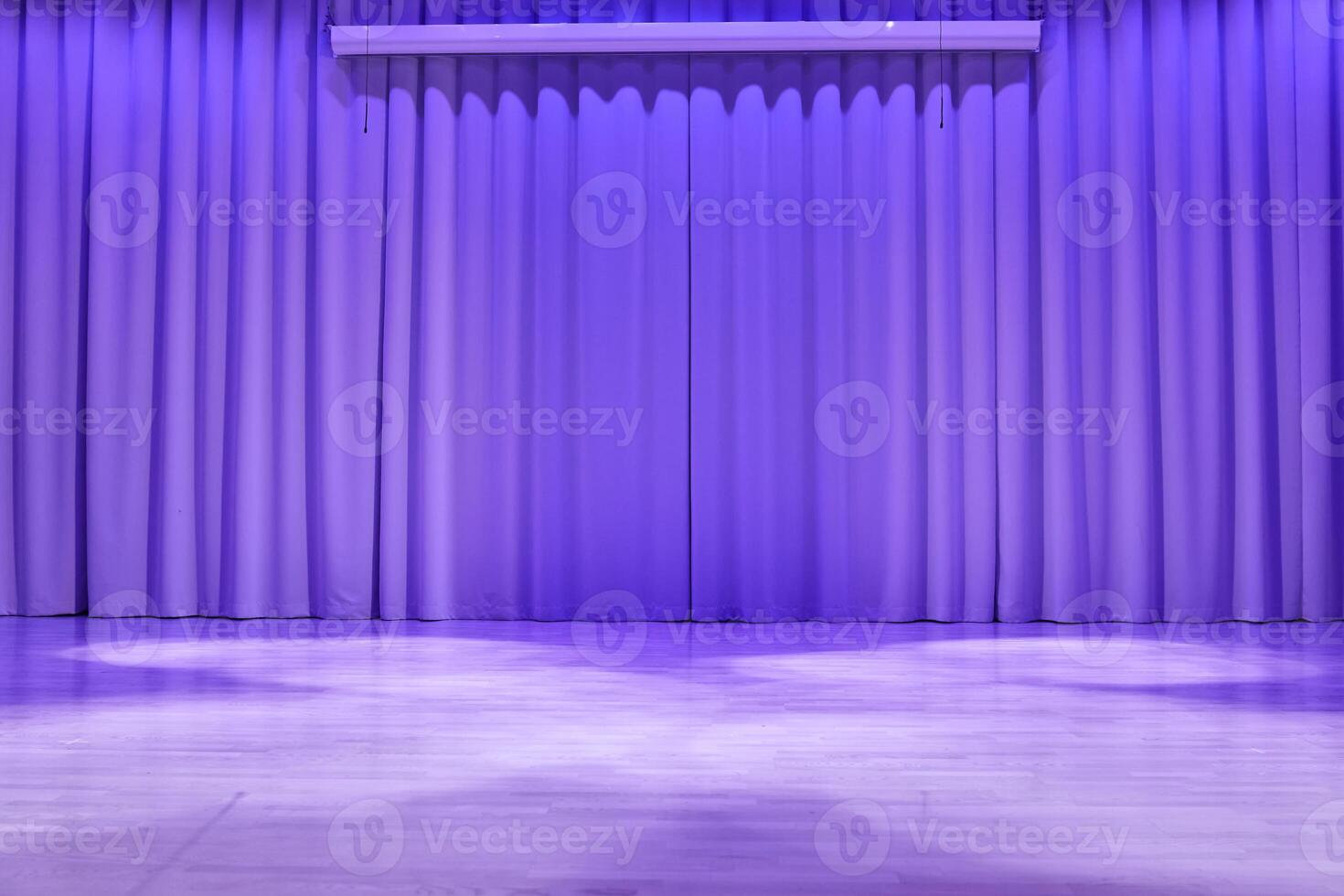 A stage with a platform in the form of a podium with trendy purple lighting. Fabric wavy background with space for copying. An element for your design photo