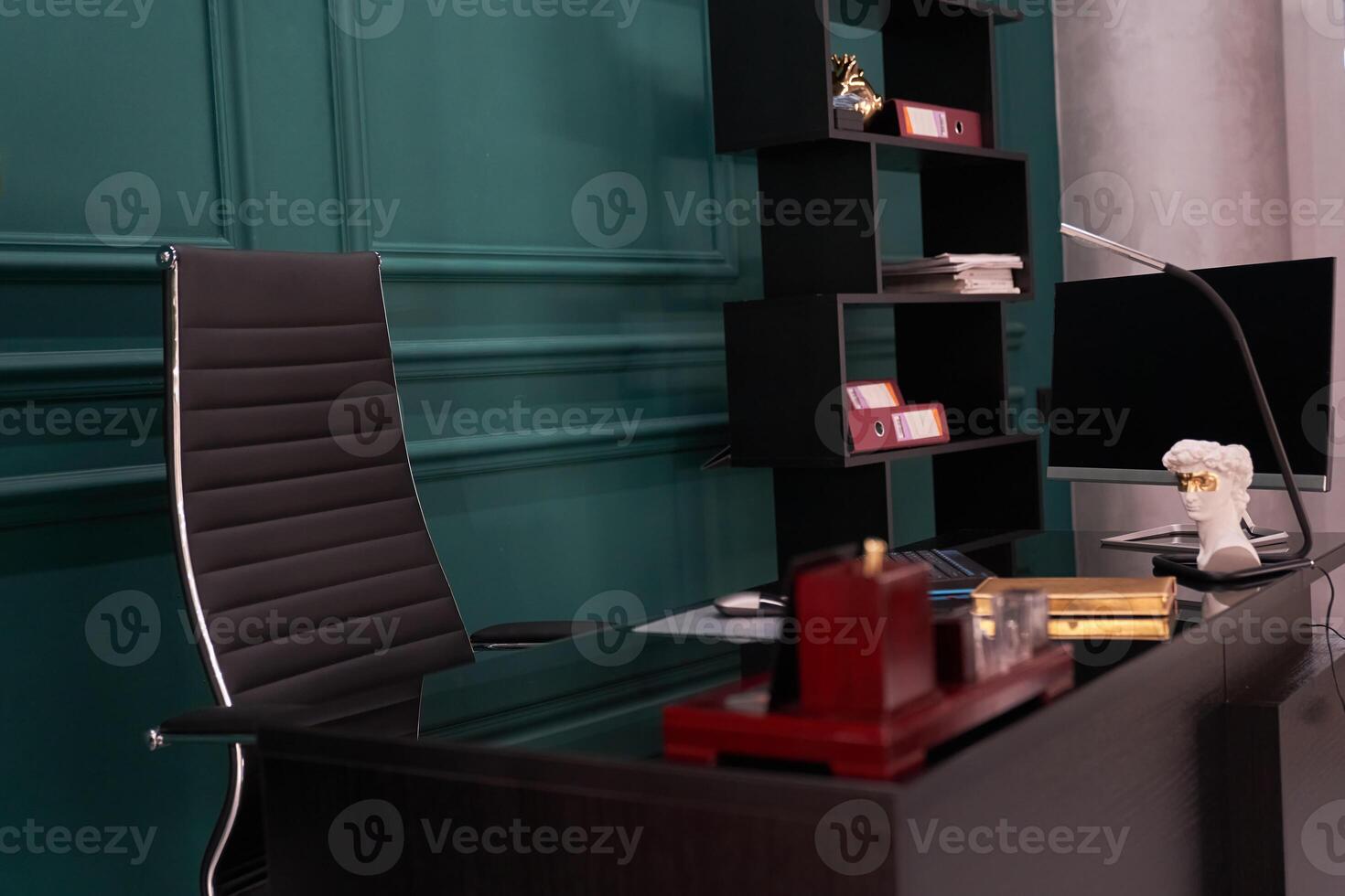 High-tech and luxurious office of the director of the company. which has a modern wooden table and an armchair photo