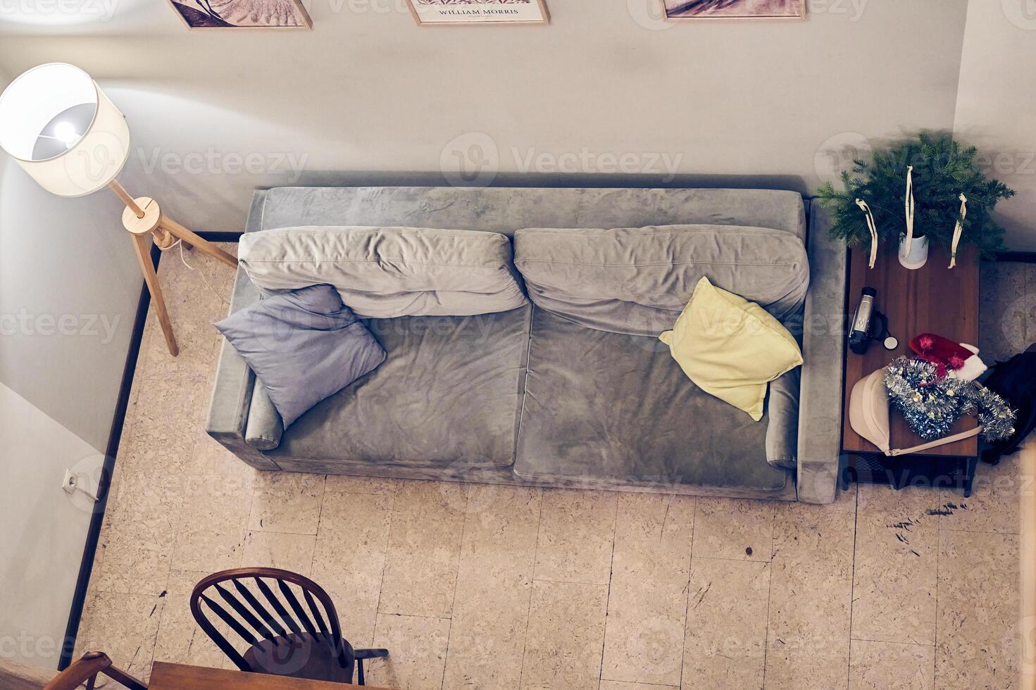Large luxurious living room interior in a country house. Top view of a soft grey sofa with large cushions. With space to copy photo