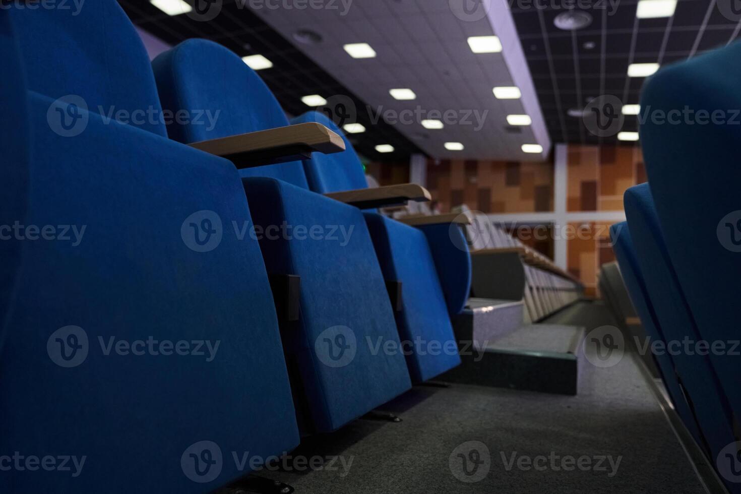 A view from below of rows of empty chairs facing the stage, illuminated by spectacular white lighting. The atmosphere suggests anticipation of an upcoming event or performance photo