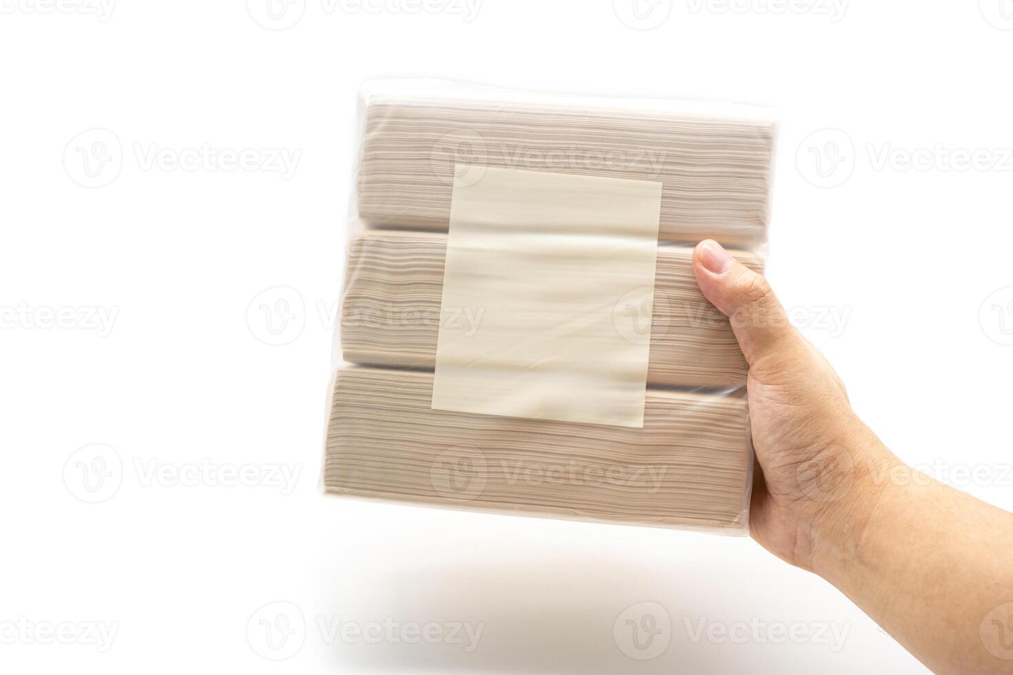 Hand holding Bamboo Tissue paper pack isolated on white background. Brown tissue. Simplicity Design. Household. Clean. Packaging design. photo
