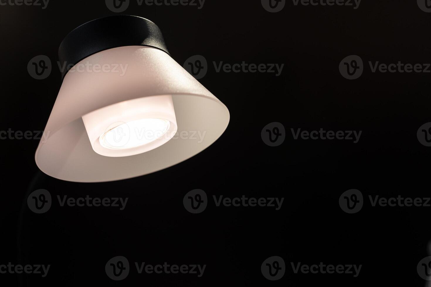 modern pendant lights hanging from a dark ceiling. Copy space. photo