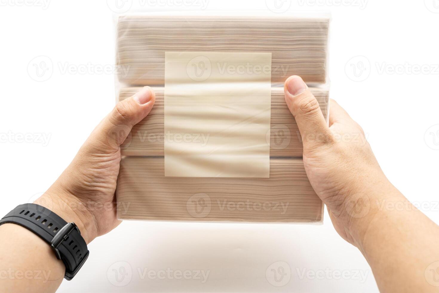 Hand holding Bamboo Tissue paper pack isolated on white background. Brown tissue. Simplicity Design. Household. Clean. Packaging design. Recycled paper. photo