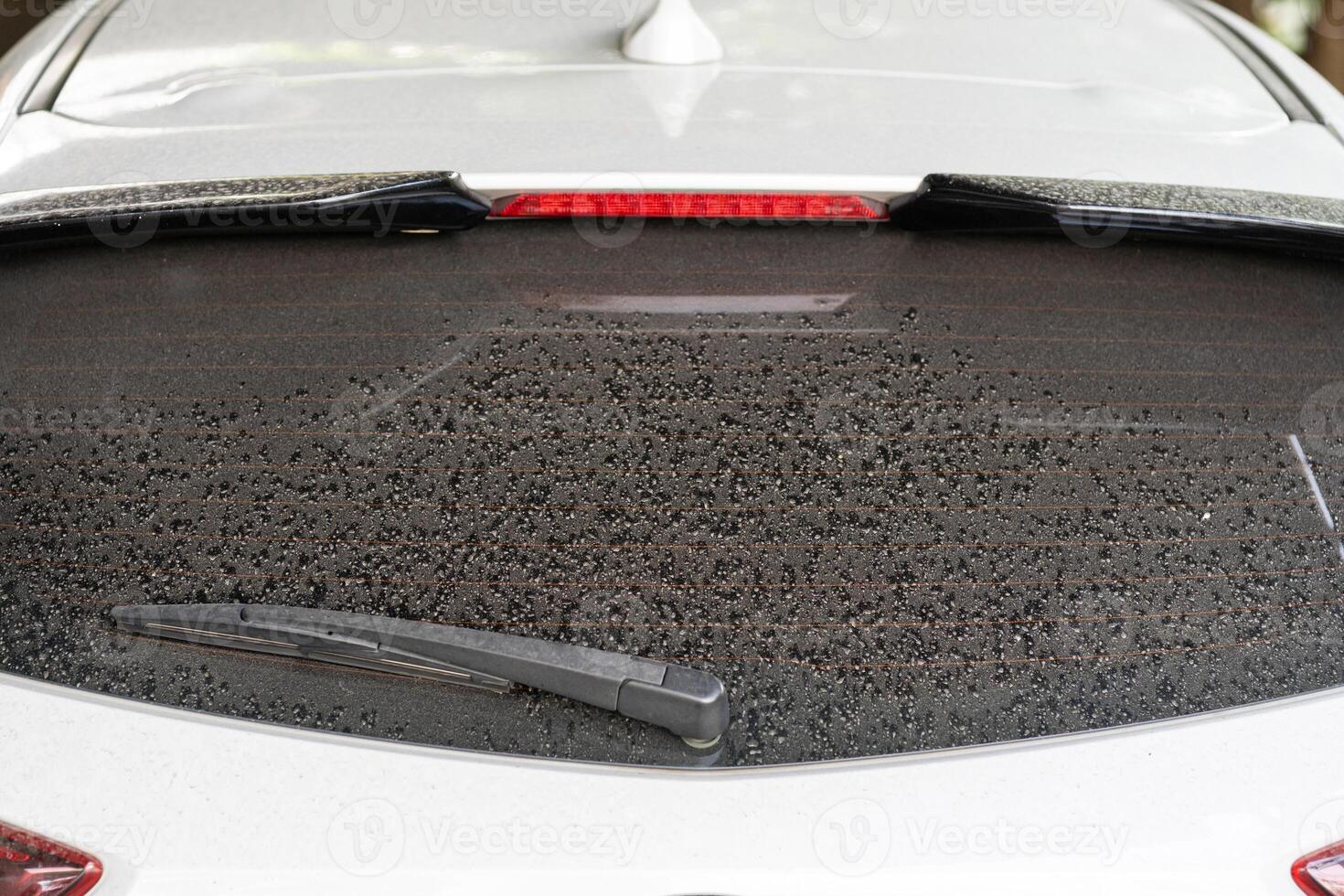 Rear window hatchback dirty car rear view on a dusty glass. photo