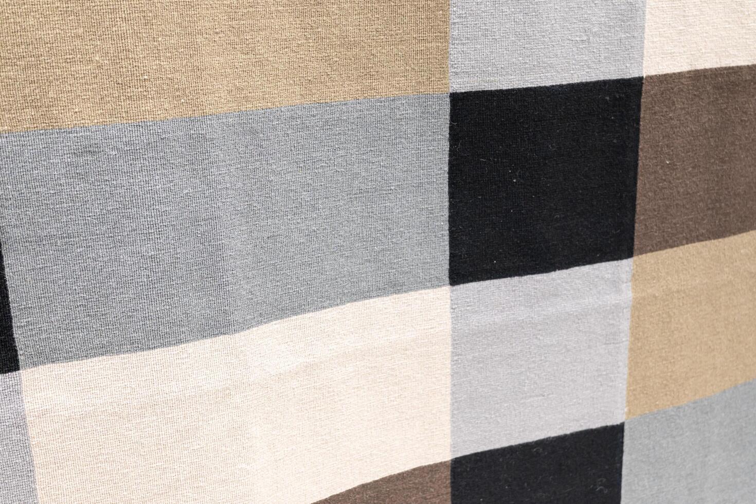 Neutral Toned Woven Fabric Checkerboard Pattern. textured woven fabric featuring a checkerboard pattern in neutral tones including beige, taupe, gray, black, and cream. photo