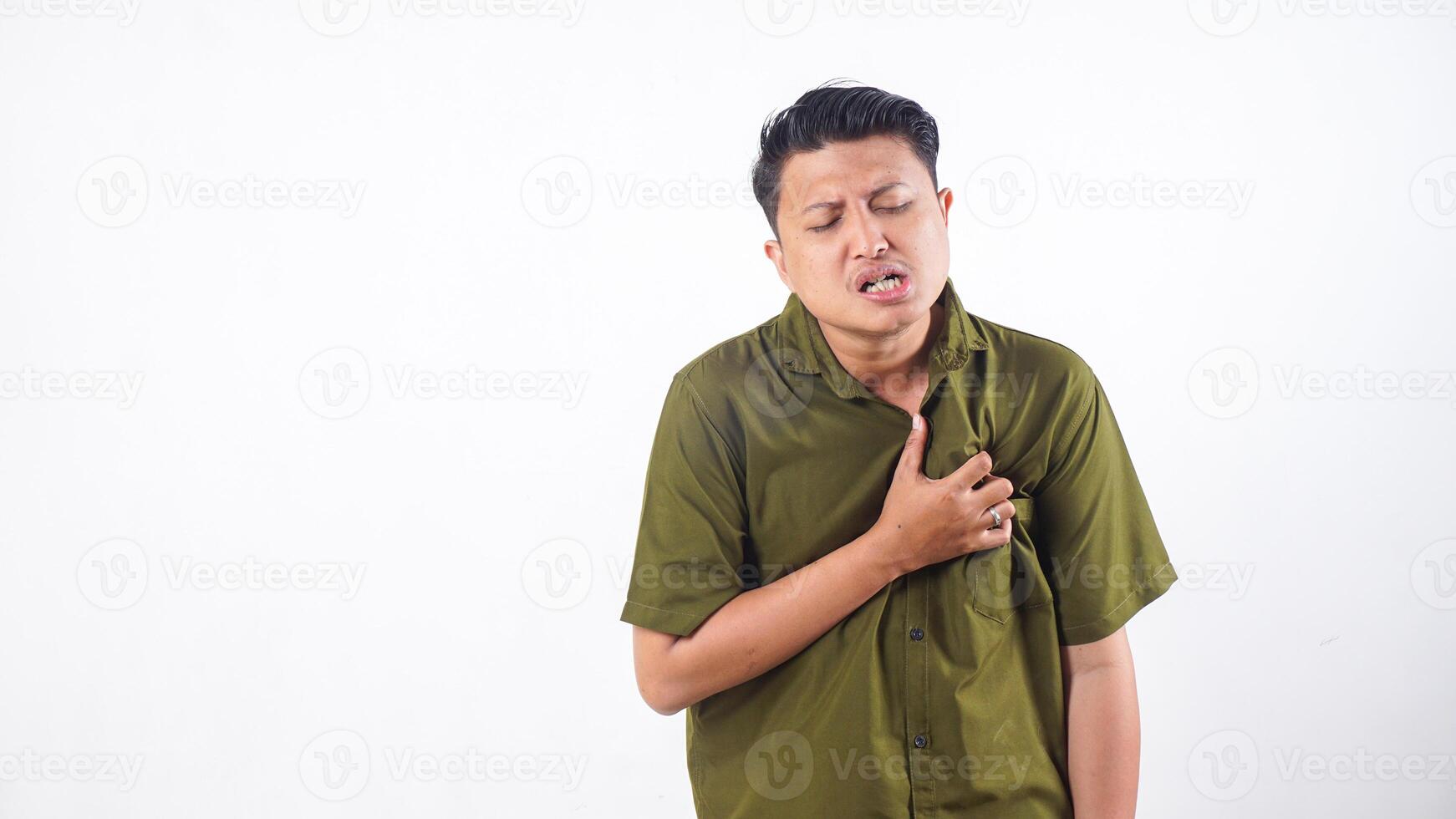 Suffering Asian male pressing hand to chest due to heart issue isolated on white background photo