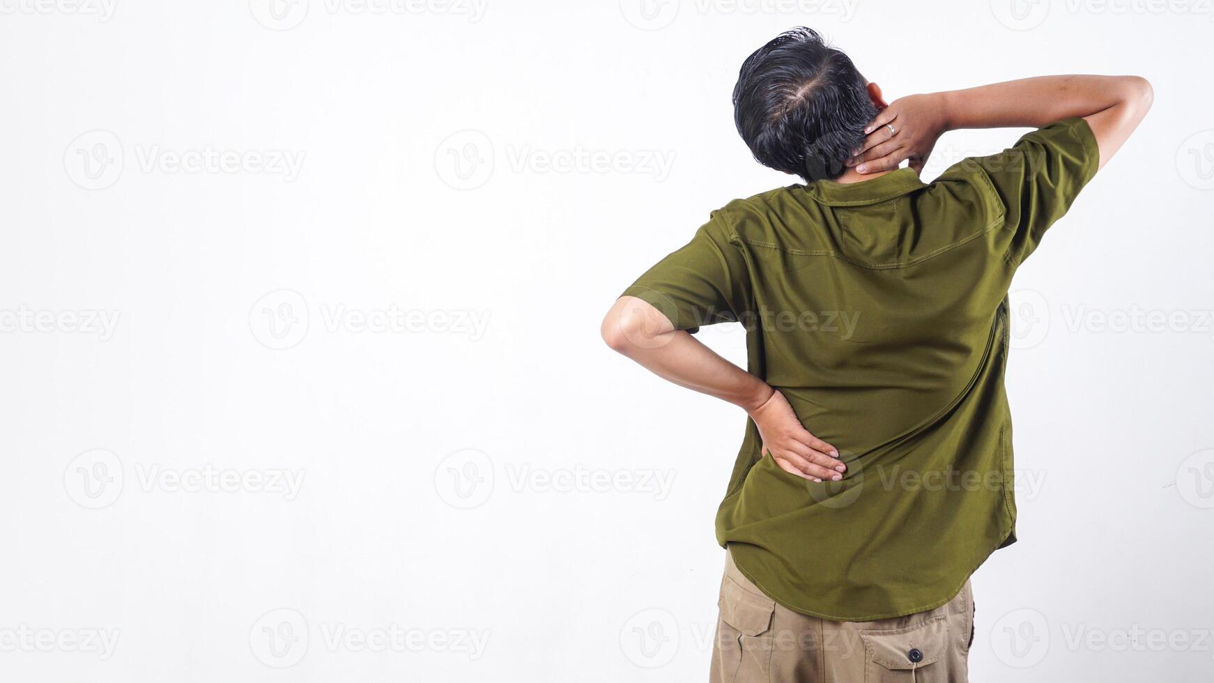 Rear view of man holding his lower back suffering from back pain isolated on white background photo