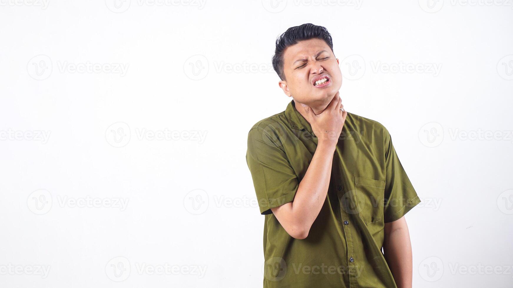 Asian man holding his throat due to suffering from sore throat isolated on white background photo
