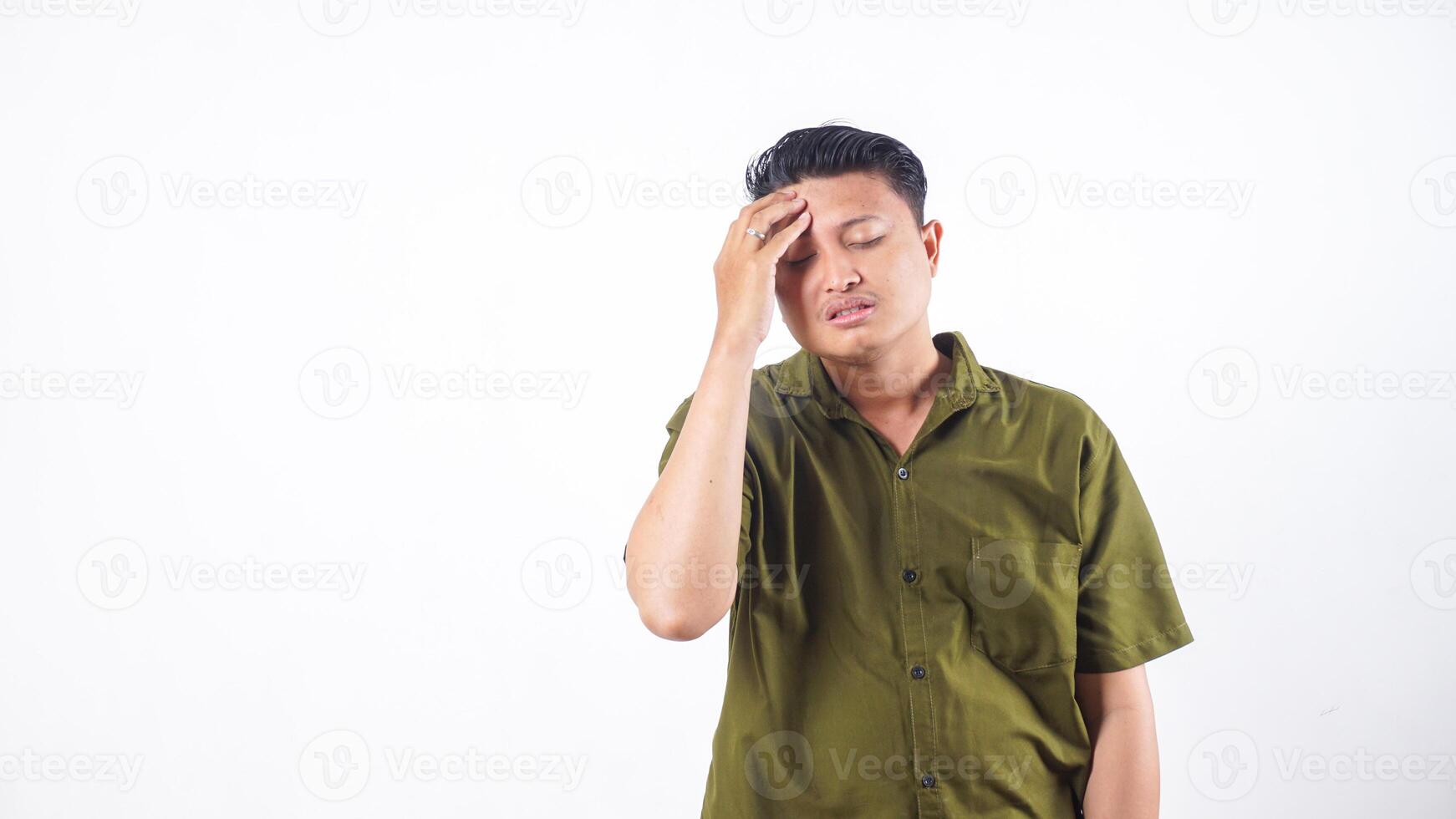 Asian man in pain touching forehead due to headache isolated on white background photo