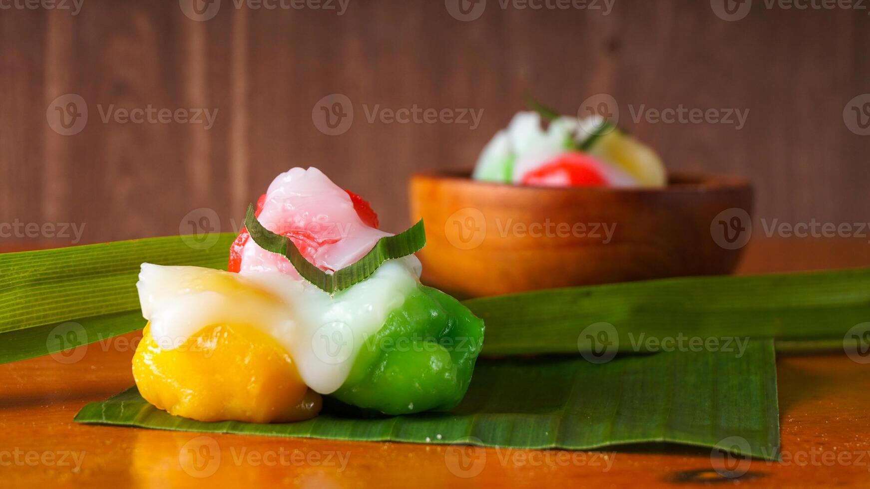 Kue Putri Mandi, a delicious traditional Indonesian snack on banana leaf isolated on white background photo