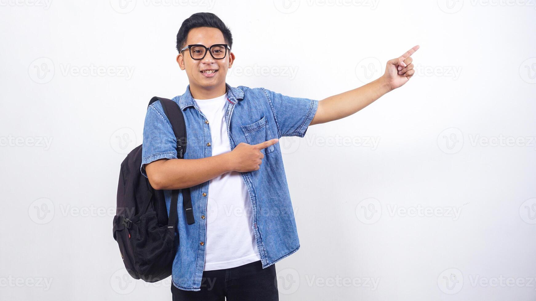 Portrait of young Asian male university student in casual outfit with backpack isolated on white background with copy space photo