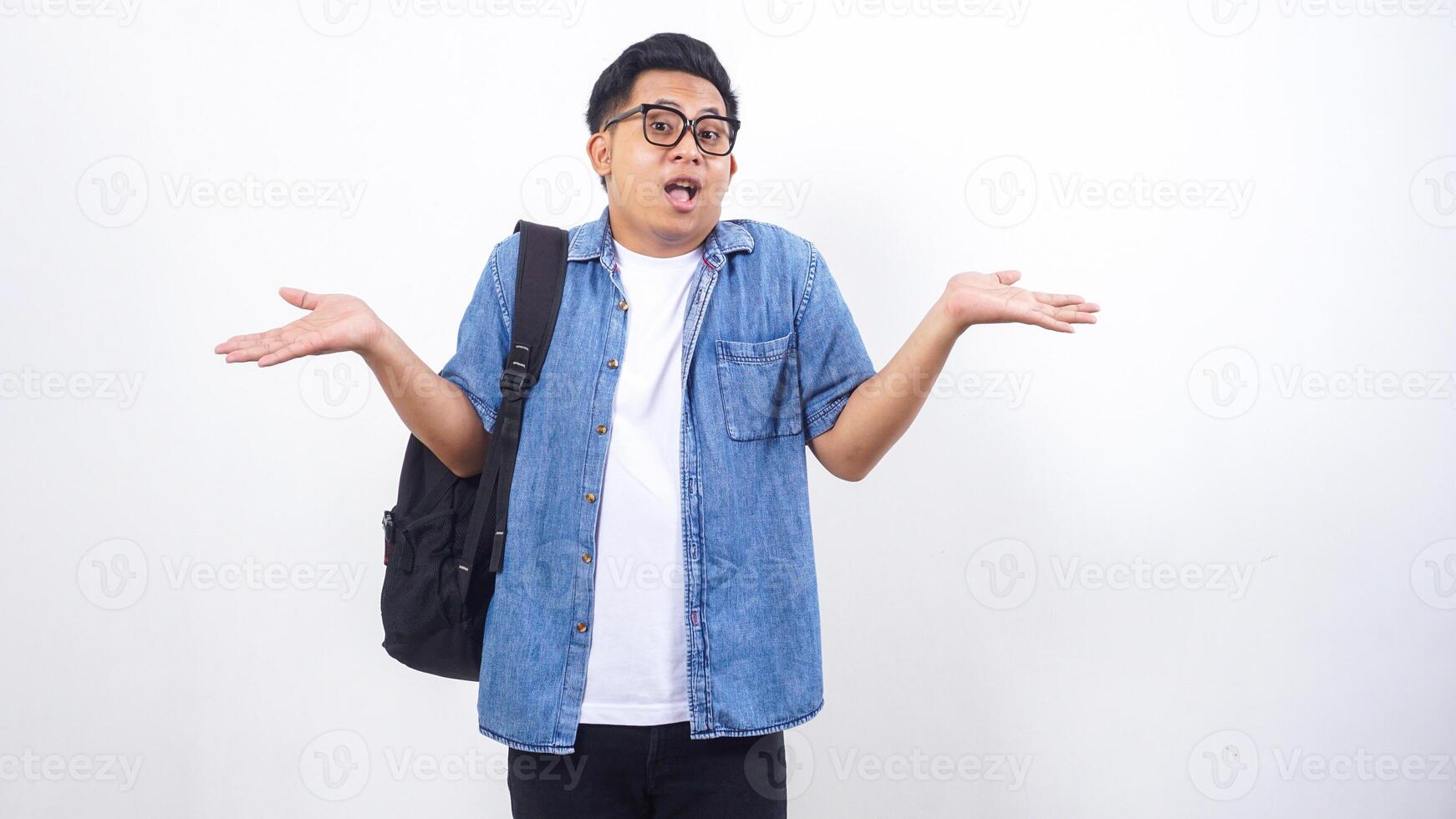 Shocked young Asian male university student in casual outfit with backpack isolated on white background photo