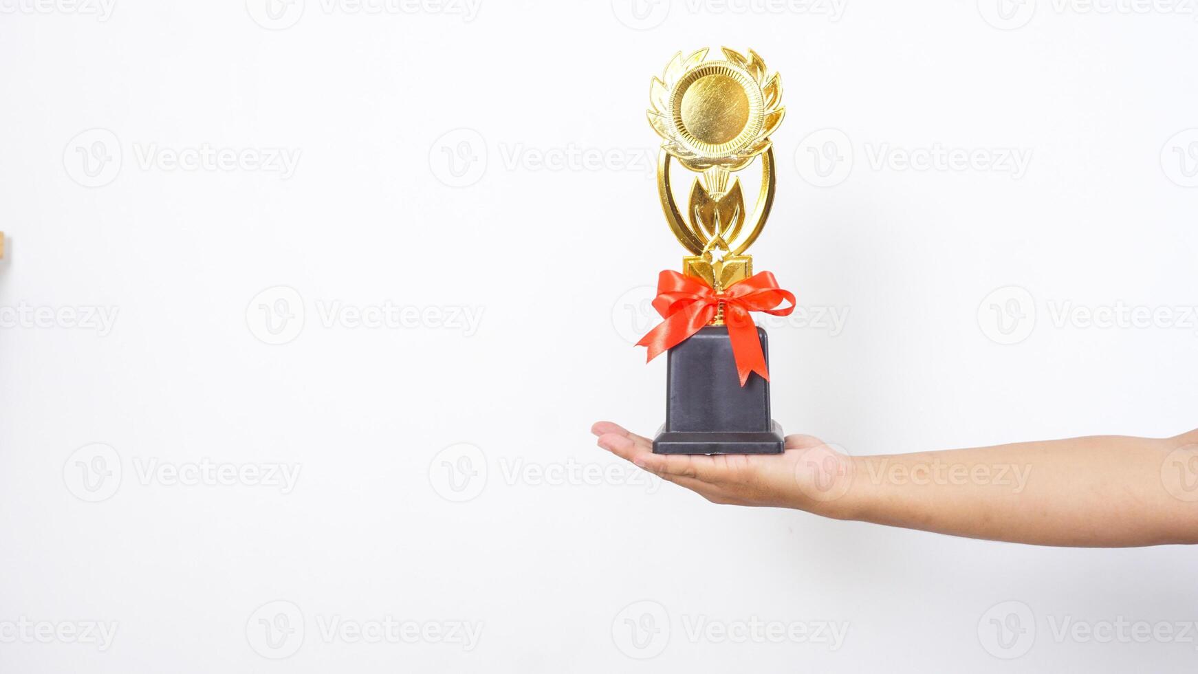 Close up of hand with trophy isolated on white background photo