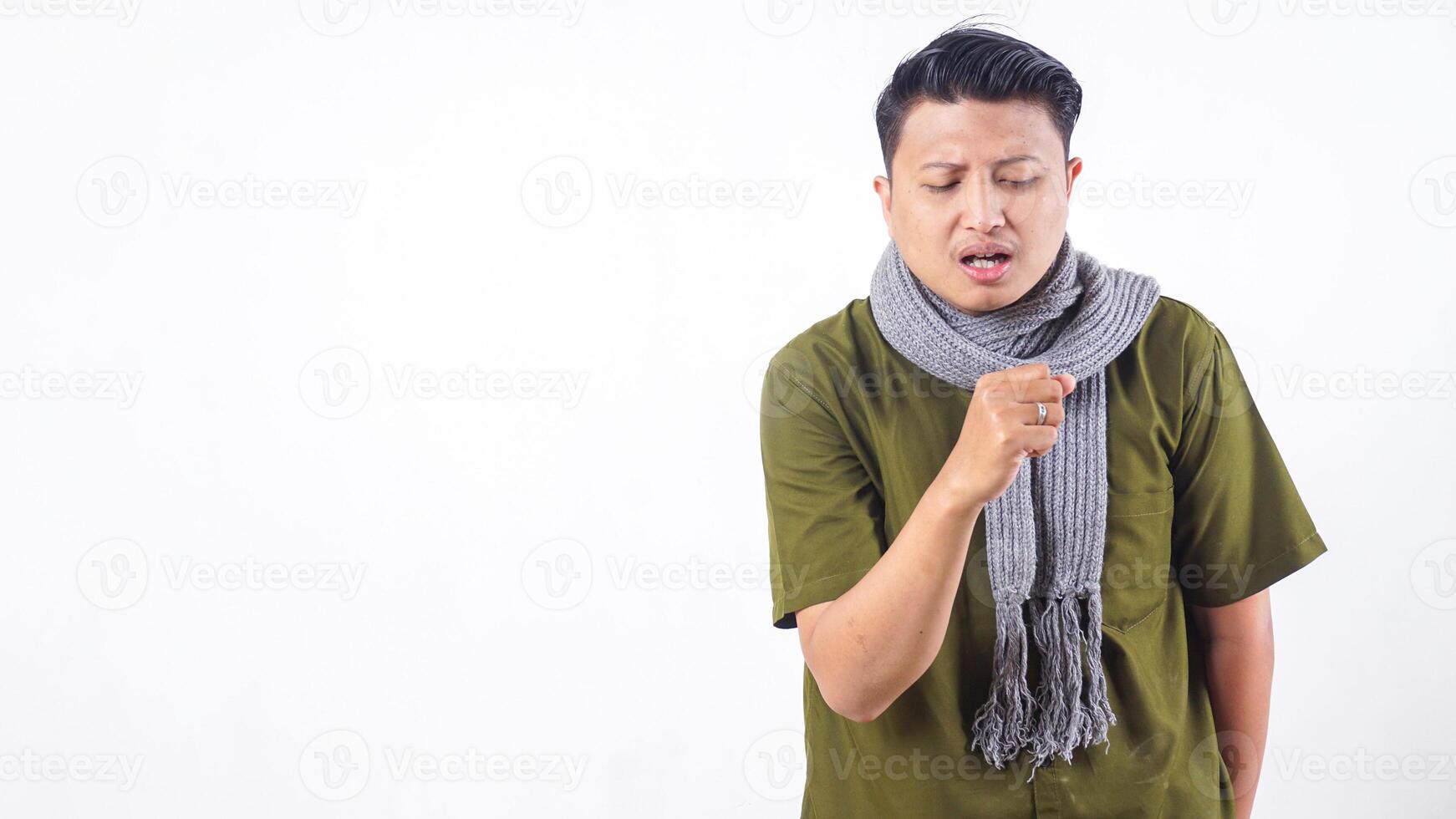 Sick adult man wearing wool scarf is coughing isolated on white background photo