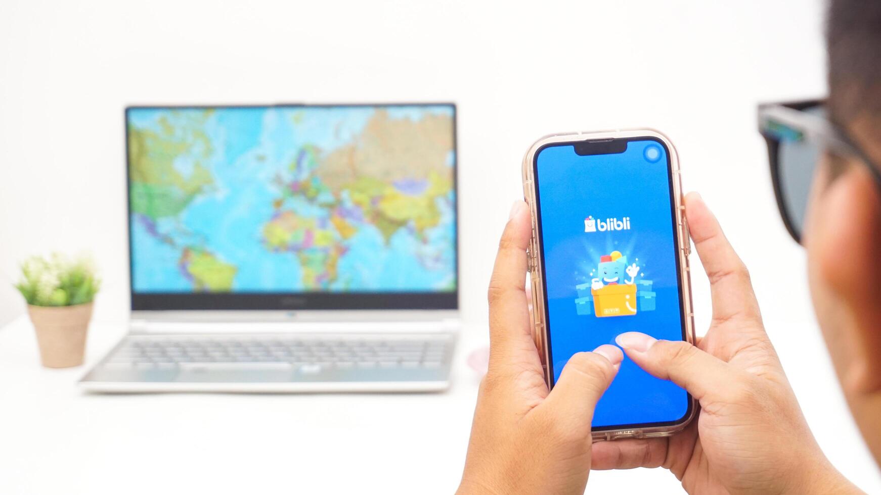 Yogyakarta, Indonesia, 2025 - Man holds smartphone with Blibli, electronic commerce platform in Indonesia application on the screen isolated on white background photo