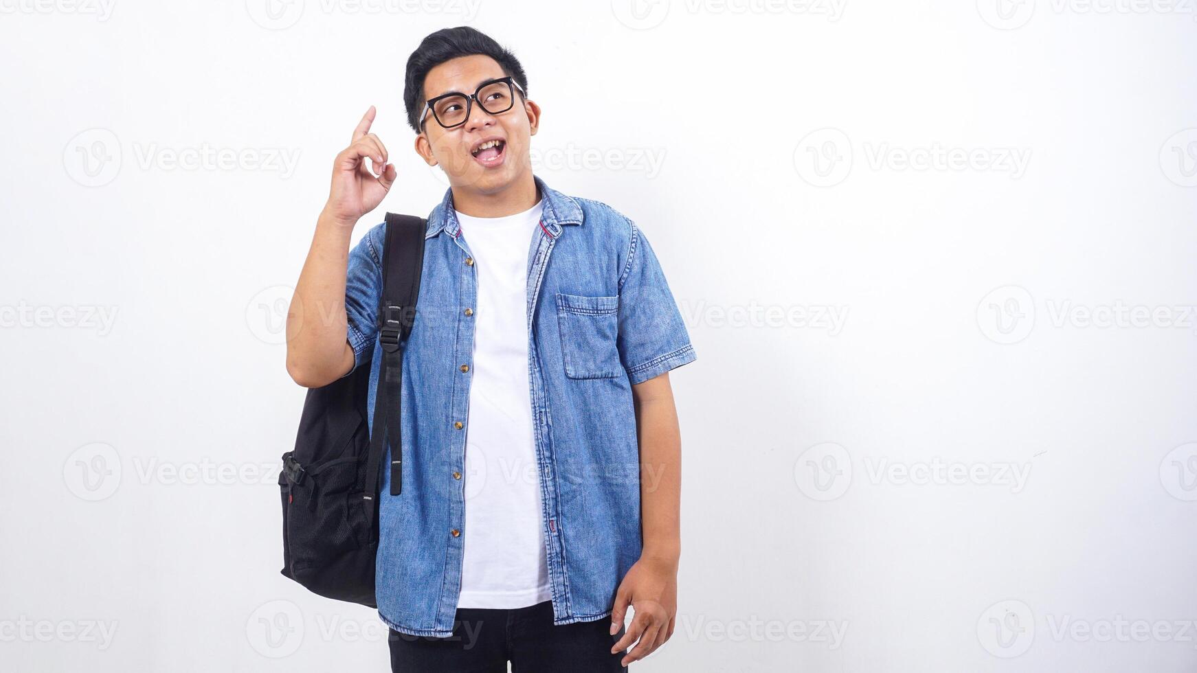 Portrait of young Asian male university student in casual outfit with backpack isolated on white background photo