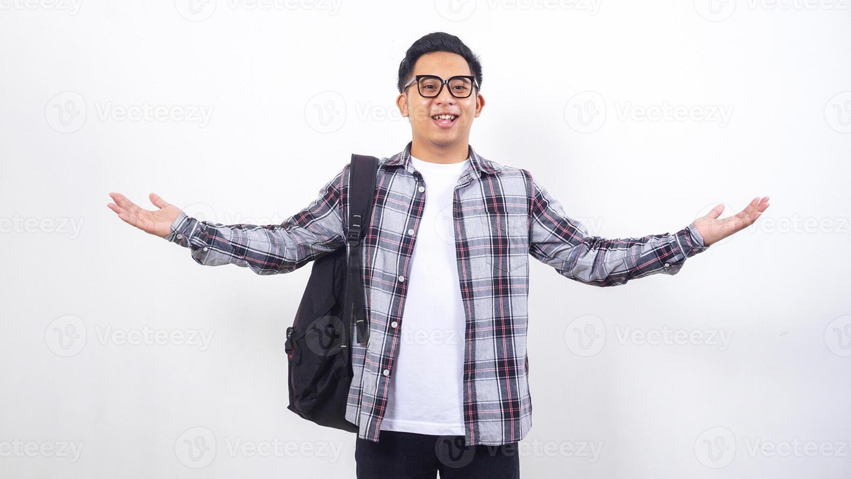 Cheerful young Asian male college student with a backpack isolated on white background photo