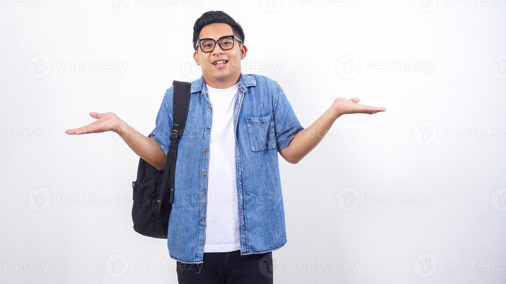 Happy young Asian male university student in casual outfit with backpack isolated on white background with copy space photo
