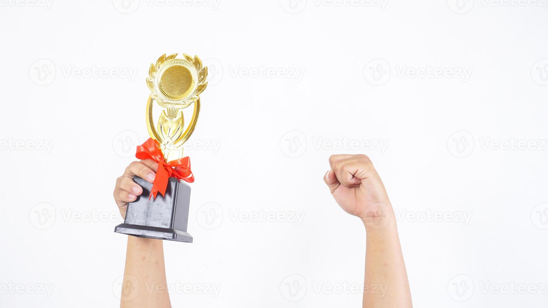 Close up of man's hand fist and holding trophy isolated on white background photo