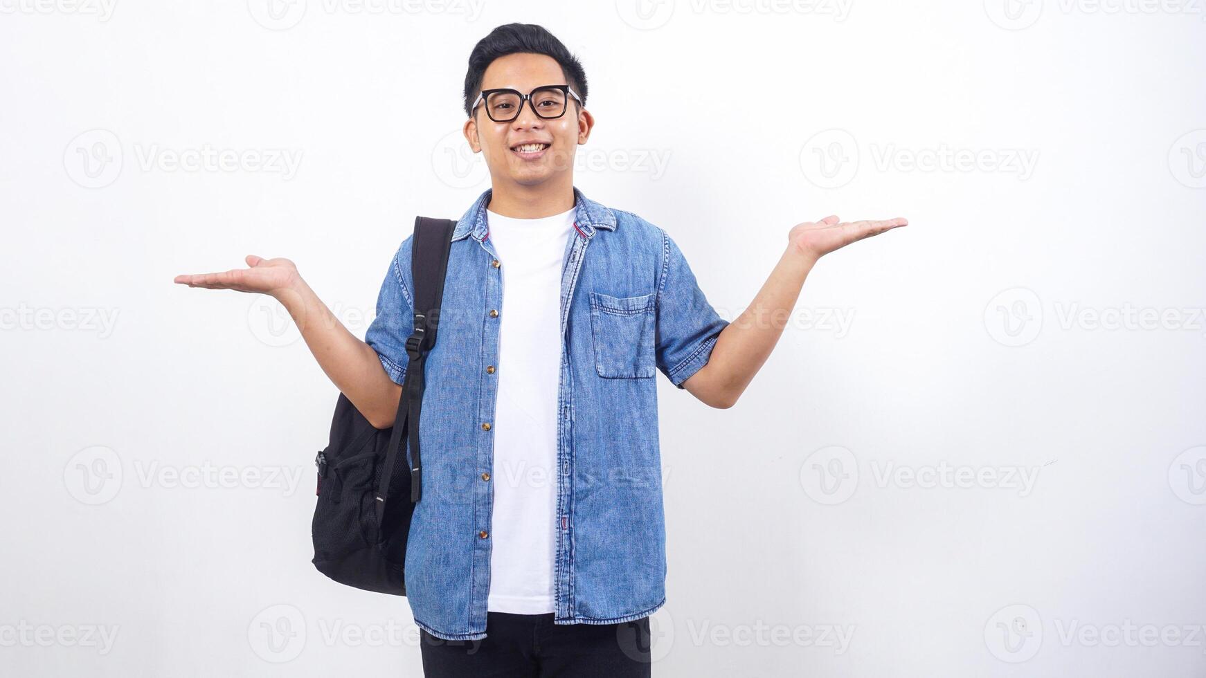 Handsome young Asian male university student in casual outfit with backpack isolated on white background with copy space photo