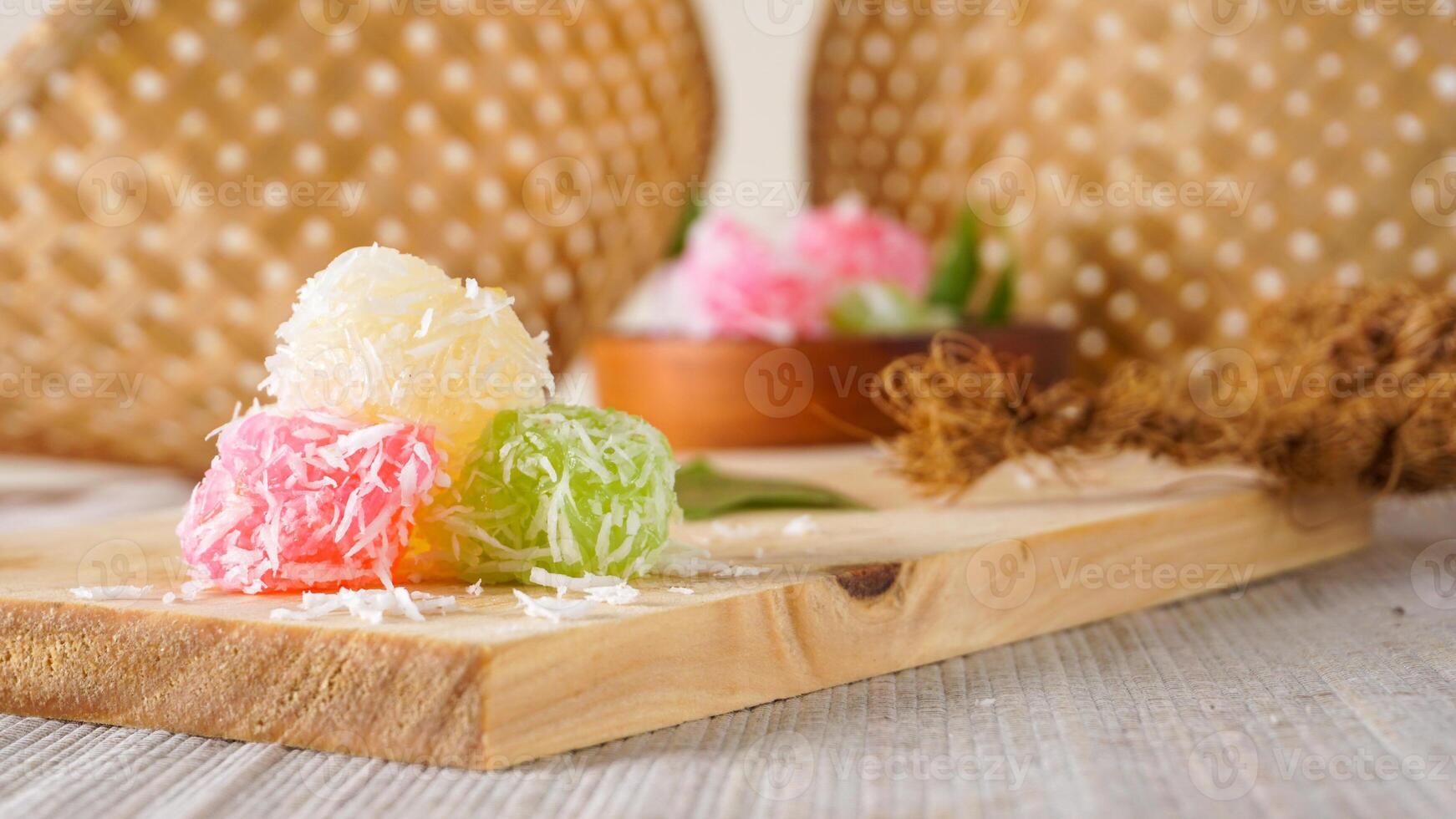 Cenil, a traditional Indonesian snack food with chewy texture on wooden platter isolated on white background photo