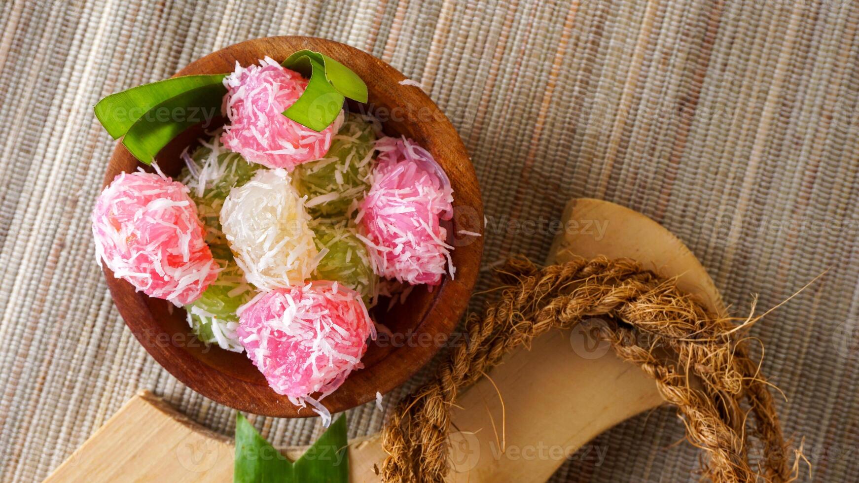 Cenil, a traditional Indonesian snack food on wooden bowl isolated on white background photo
