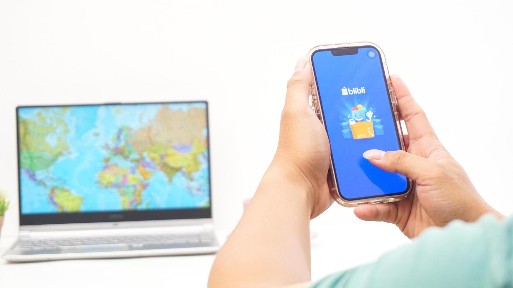 Yogyakarta, Indonesia, 2025 - Man holding smartphone with Blibli, electronic commerce platform in Indonesia application on the screen isolated on white background photo