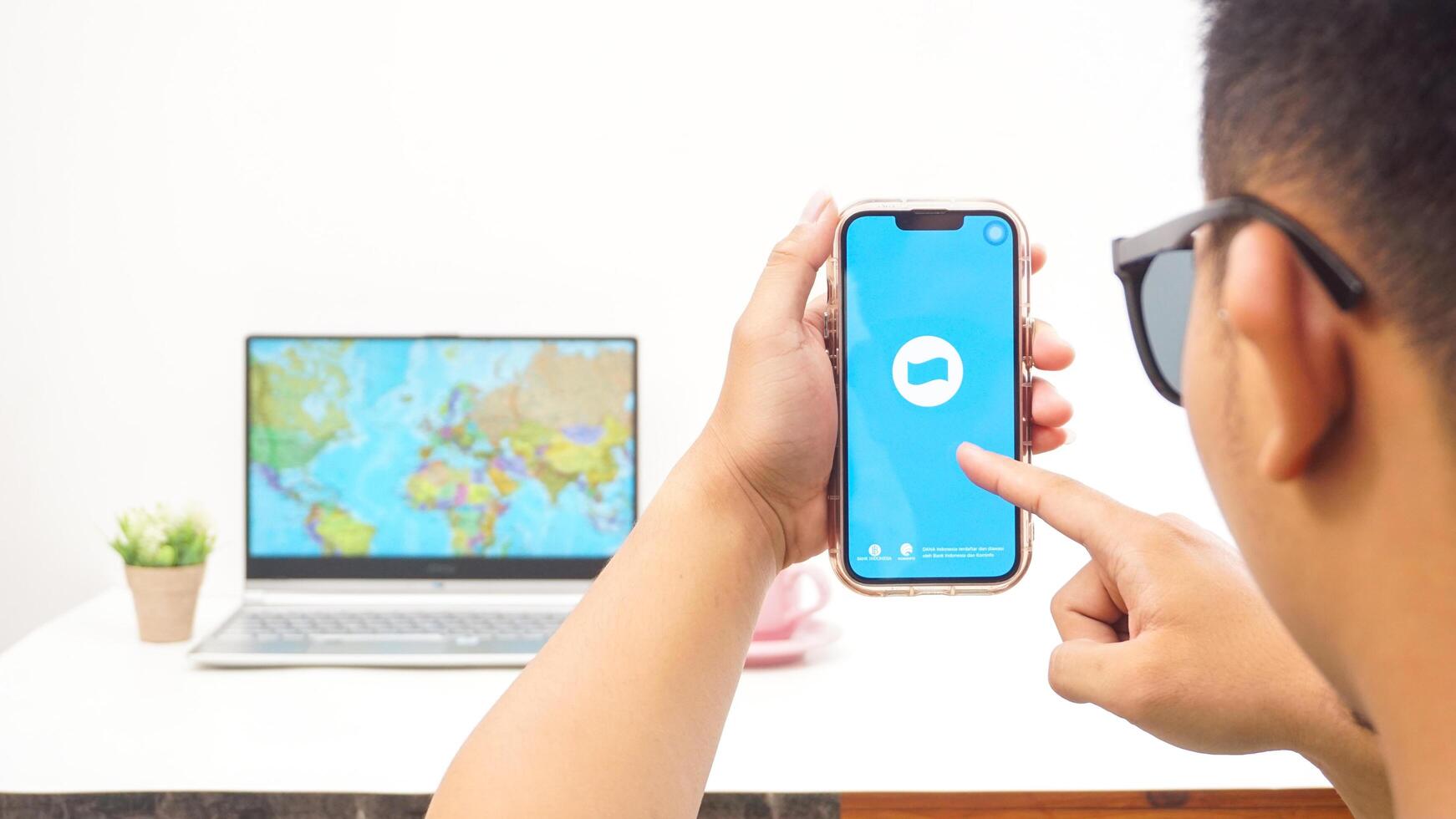 Yogyakarta, Indonesia, 2025 - Man holding smartphone with DANA, digital wallet in Indonesia application on the screen isolated on white background photo
