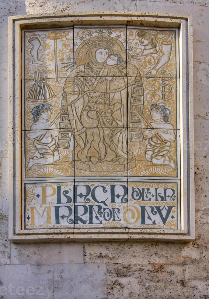 Decorative and intricate element, part of the Valencia Cathedral in Spain, showcasing religious artwork. photo