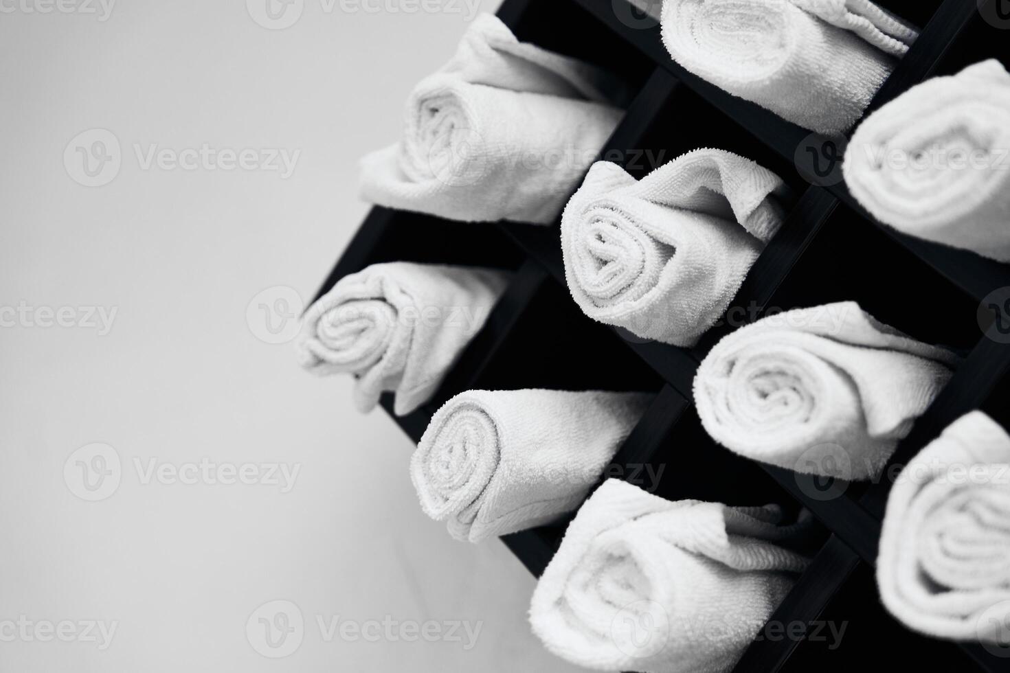 Neatly arranged white towels in a spa setting create a calming atmosphere photo