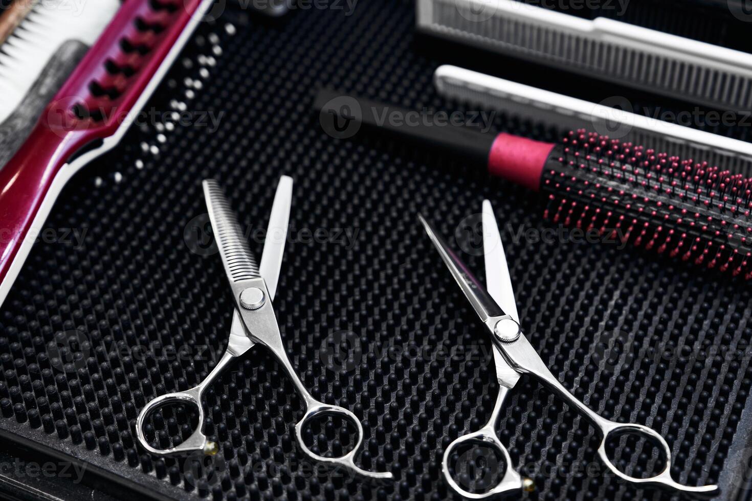 Quality hair scissors and styling tools arranged on a salon table photo