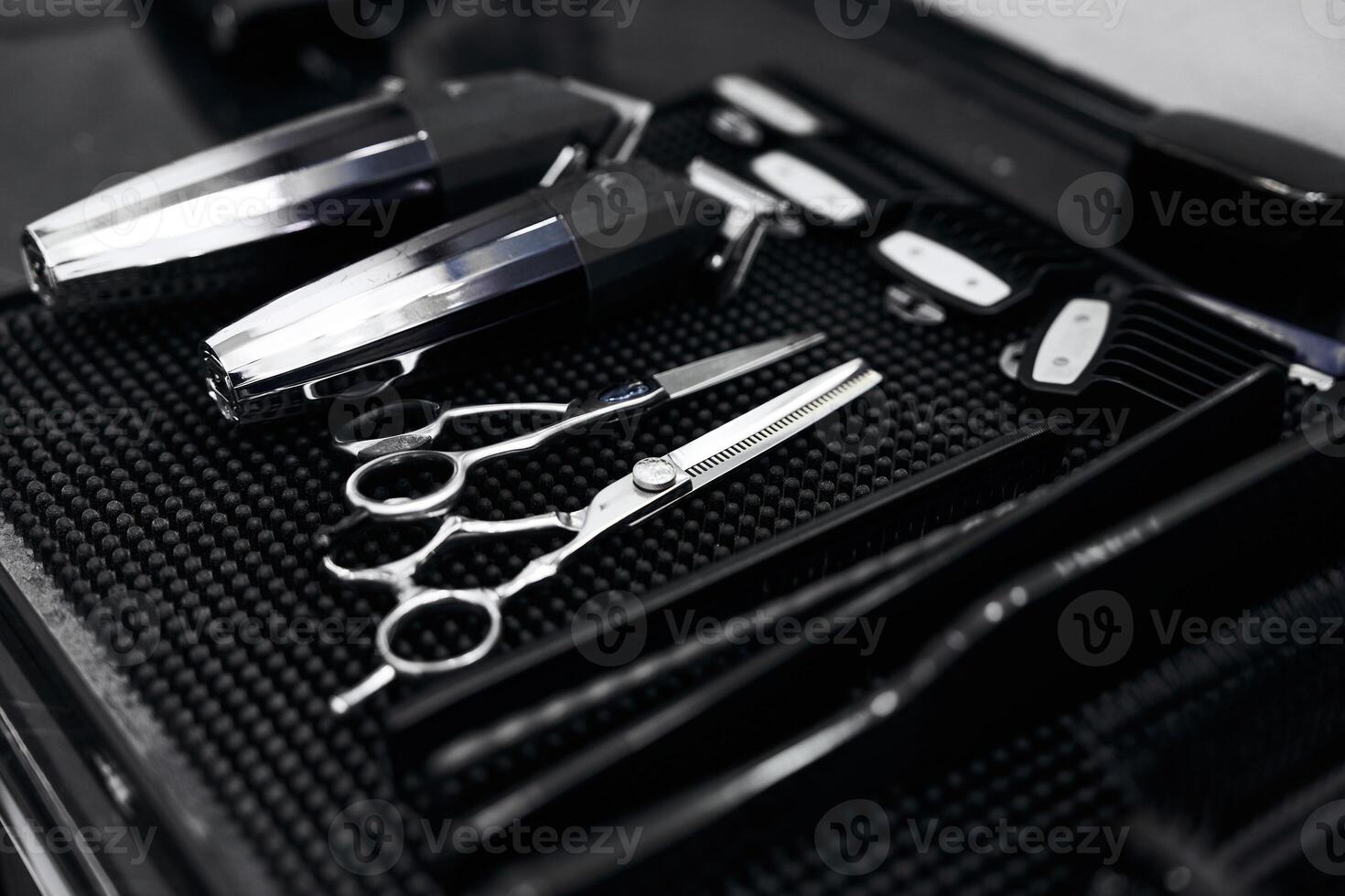 Professional barber tools neatly arranged on a work surface in a salon photo