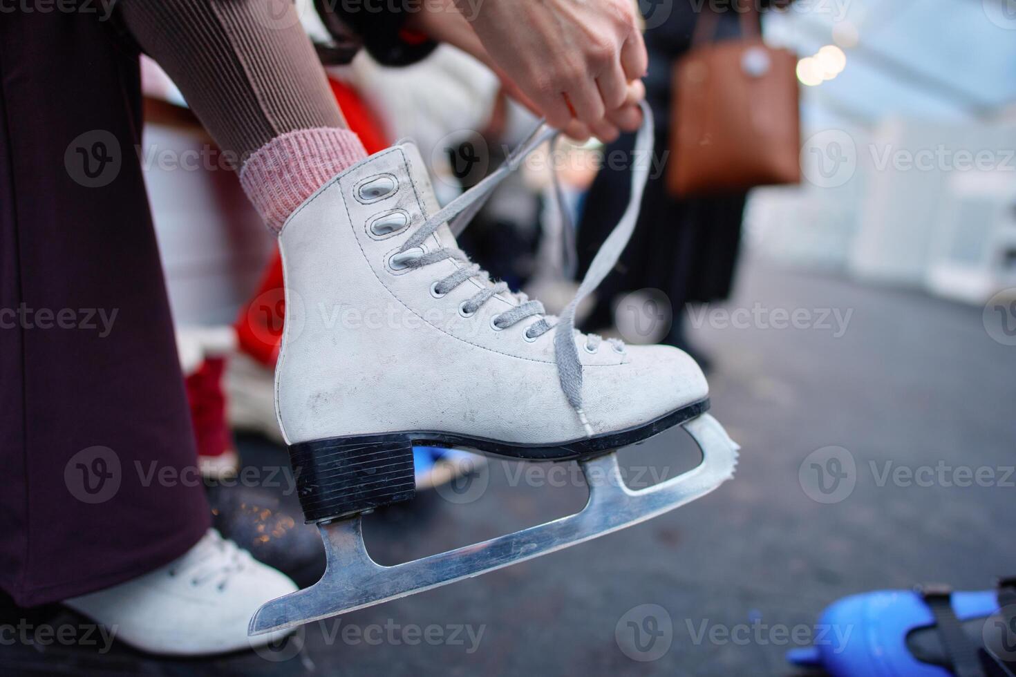 Skater prepares for a session on ice during winter festivities in a rink photo