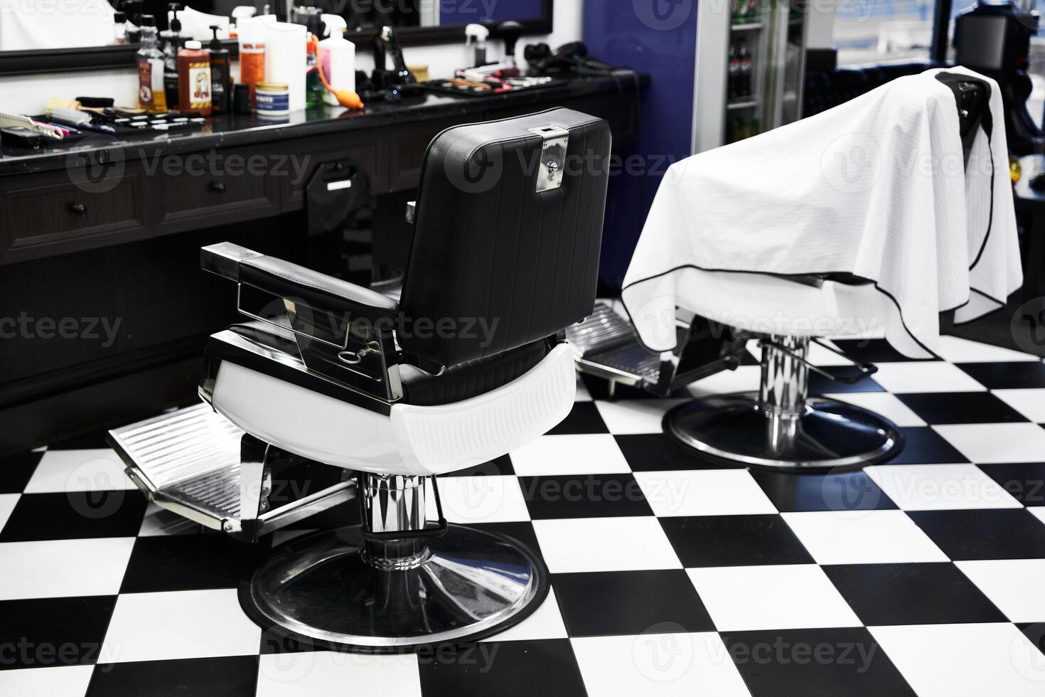 Stylish barbershop interior with two empty barber chairs waiting for customers photo
