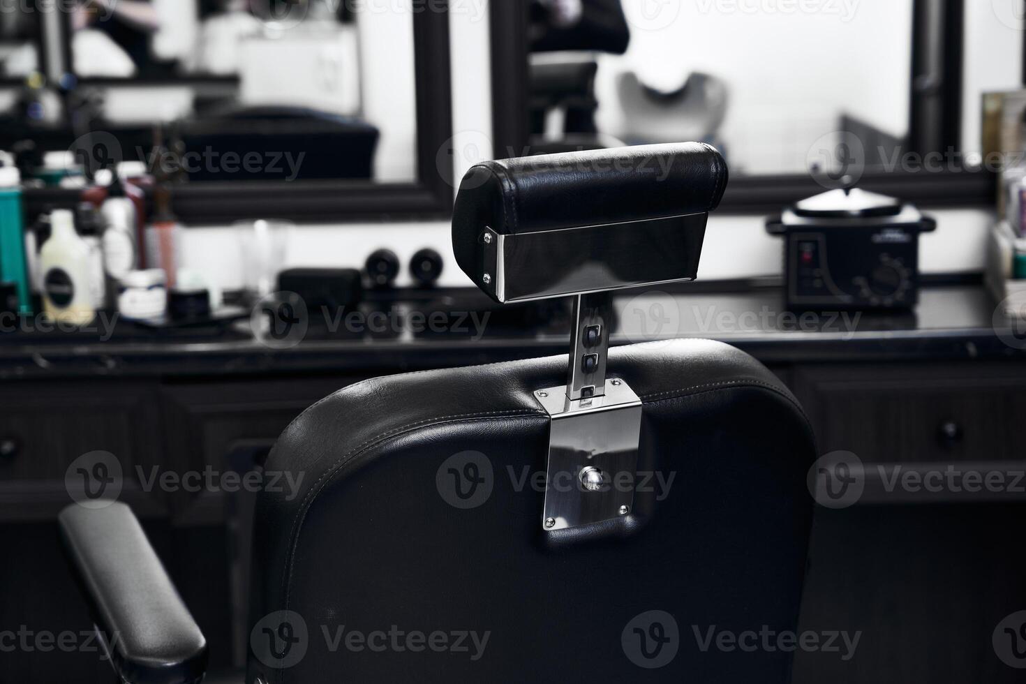 Black barber chair in a stylish salon with modern decor and tools photo